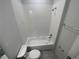 Bright bathroom with white tiles, bathtub and shower combination, and modern fixtures at 3408 Curlew Ave, Leesburg, FL 34748