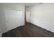This bedroom features a closet with hard wood floors and neutral walls at 3408 Curlew Ave, Leesburg, FL 34748