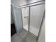 This bathroom showcases a standalone shower with clear doors, white tiles, and modern showerhead at 3408 Curlew Ave, Leesburg, FL 34748