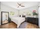 Bedroom with hardwood floors, neutral colors, and a large mirror and windows at 3520 Sebring Ave, Orlando, FL 32806