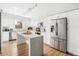 Bright modern kitchen with stainless steel appliances, white cabinets, and a quartz countertop island at 3520 Sebring Ave, Orlando, FL 32806