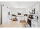 Bright kitchen with white cabinets, stainless steel appliances, and a spacious island with barstool seating at 3520 Sebring Ave, Orlando, FL 32806