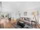 Bright living room featuring hardwood floors, a comfortable sofa, and an adjacent dining area at 3520 Sebring Ave, Orlando, FL 32806