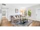 Comfortable living room with a large window, contemporary decor, and hardwood floors at 3520 Sebring Ave, Orlando, FL 32806