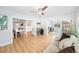 Spacious living room with a ceiling fan and wood floors overlooking the dining room at 3520 Sebring Ave, Orlando, FL 32806