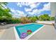 Backyard swimming pool with clear blue water, surrounded by a concrete deck and green foliage, ideal for outdoor relaxation at 3520 Sebring Ave, Orlando, FL 32806
