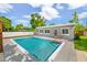 Backyard swimming pool with inflatables, surrounded by a gray deck and a modern gray house, perfect for summer fun at 3520 Sebring Ave, Orlando, FL 32806