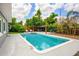 Backyard swimming pool with a lounge area and a well-maintained landscape, creating a private oasis for relaxation and entertainment at 3520 Sebring Ave, Orlando, FL 32806