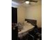 Cozy bedroom with a ceiling fan, a window with dark curtains, and a messy bed at 3582 Forster Ave, Leesburg, FL 34748