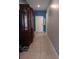 Inviting hallway with tile flooring, a decorative cabinet, and soothing blue walls at 3582 Forster Ave, Leesburg, FL 34748