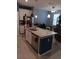Another view of kitchen showcasing the granite island, stainless steel appliances, and overhead lighting at 3582 Forster Ave, Leesburg, FL 34748