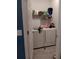 Bright laundry room with side-by-side washer and dryer and shelving for storage at 3582 Forster Ave, Leesburg, FL 34748