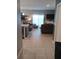 Open-concept living room featuring tile floors, comfortable seating, and sliding glass doors to the backyard at 3582 Forster Ave, Leesburg, FL 34748