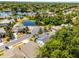 Aerial shot features homes nestled near a pond, surrounded by green trees, under a blue sky at 4027 Lakeside Reserve Ct, Orlando, FL 32810