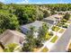 Aerial showcases home with lush landscape, mature trees, and proximity to neighborhood streets at 4027 Lakeside Reserve Ct, Orlando, FL 32810
