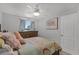 Bright bedroom with a ceiling fan, a colorful bed, and natural light at 4027 Lakeside Reserve Ct, Orlando, FL 32810