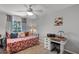Cozy bedroom with a ceiling fan, work desk, and a comfortable bed at 4027 Lakeside Reserve Ct, Orlando, FL 32810