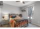 Charming bedroom with iron bed frame and natural light from the window at 4027 Lakeside Reserve Ct, Orlando, FL 32810