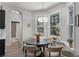 Bright breakfast nook with backyard views, table, and chandelier at 4027 Lakeside Reserve Ct, Orlando, FL 32810