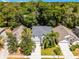 Charming single Gathering home with mature trees, a gray roof and a well-manicured lawn at 4027 Lakeside Reserve Ct, Orlando, FL 32810