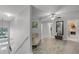 Hallway with wood floors leads to bedrooms and laundry room with plenty of natural light at 4027 Lakeside Reserve Ct, Orlando, FL 32810