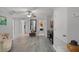 Hallway leads to the bedrooms and laundry room with warm natural light and wood-look floors at 4027 Lakeside Reserve Ct, Orlando, FL 32810