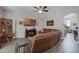 Cozy living room featuring a large leather sofa and modern ceiling fan at 4027 Lakeside Reserve Ct, Orlando, FL 32810