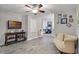 Cozy living room with wood-look flooring, ceiling fan, and an inviting couch at 4027 Lakeside Reserve Ct, Orlando, FL 32810
