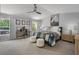 Spacious main bedroom with a ceiling fan, desk, and natural light at 4027 Lakeside Reserve Ct, Orlando, FL 32810