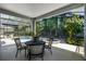 Comfortable covered patio overlooking a swimming pool and mature trees at 4027 Lakeside Reserve Ct, Orlando, FL 32810