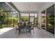 Covered outdoor patio features a table and chairs for dining and relaxing at 4027 Lakeside Reserve Ct, Orlando, FL 32810