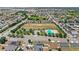 Expansive aerial view of a residential community featuring a community pool and playground with mature trees and manicured lawns at 4215 Swan St, Haines City, FL 33844