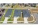 Aerial view of homes showcases the putting green in the backyard of the center home at 4215 Swan St, Haines City, FL 33844