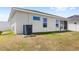 Rear exterior of the house with a screened in patio, air conditioning and a view of the backyard at 4215 Swan St, Haines City, FL 33844