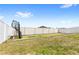 Spacious backyard with a putting green and tall white vinyl fencing all around at 4215 Swan St, Haines City, FL 33844