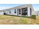 Rear exterior of the house with a screened in patio and views of the backyard at 4215 Swan St, Haines City, FL 33844