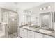 Bathroom with double sinks, granite countertops and tiled shower at 4215 Swan St, Haines City, FL 33844