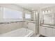 Bright bathroom features a soaking tub and a glass enclosed shower at 4215 Swan St, Haines City, FL 33844