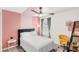 Bedroom with decorative pink and white walls, ceiling fan and carpet at 4215 Swan St, Haines City, FL 33844