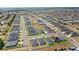 Panoramic aerial view showcases a neighborhood with many similar single Gathering homes at 4215 Swan St, Haines City, FL 33844