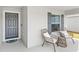 Inviting front porch with cozy seating, complemented by a stylish door and window with modern shutters at 4215 Swan St, Haines City, FL 33844