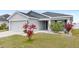 Attractive single-Gathering home with a well-maintained lawn, attached garage, and inviting entrance at 4215 Swan St, Haines City, FL 33844
