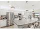Modern kitchen featuring stainless steel appliances, granite countertops, pendant lighting, and breakfast bar at 4215 Swan St, Haines City, FL 33844