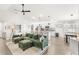 Open-concept living room with a plush sectional, modern lighting, and seamless flow to the kitchen at 4215 Swan St, Haines City, FL 33844