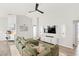 Bright living room featuring a comfortable sectional sofa, modern entertainment center, and stylish decor at 4215 Swan St, Haines City, FL 33844