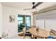 Covered patio includes a ceiling fan, an oval table and view of the fenced backyard at 4215 Swan St, Haines City, FL 33844