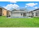 Relaxing screened-in pool with ample patio space, set in a spacious backyard with green grass at 4347 Creekside Blvd, Kissimmee, FL 34746