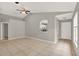 Open living room with tile floors, high ceilings, neutral paint, and a view of the kitchen at 4347 Creekside Blvd, Kissimmee, FL 34746