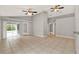 Expansive living area with tile flooring, ceiling fans, and sliding glass doors to outdoor space at 4347 Creekside Blvd, Kissimmee, FL 34746