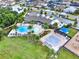 Aerial view of community pool, clubhouse, splash pad, and playground in a residential neighborhood at 4591 Gliding Wave St, Winter Garden, FL 34787